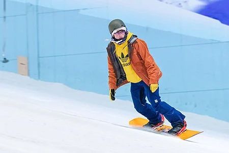 Snowboarder wearing brightly coloured clothing riding at Chill Factor<sup>e</sup>.